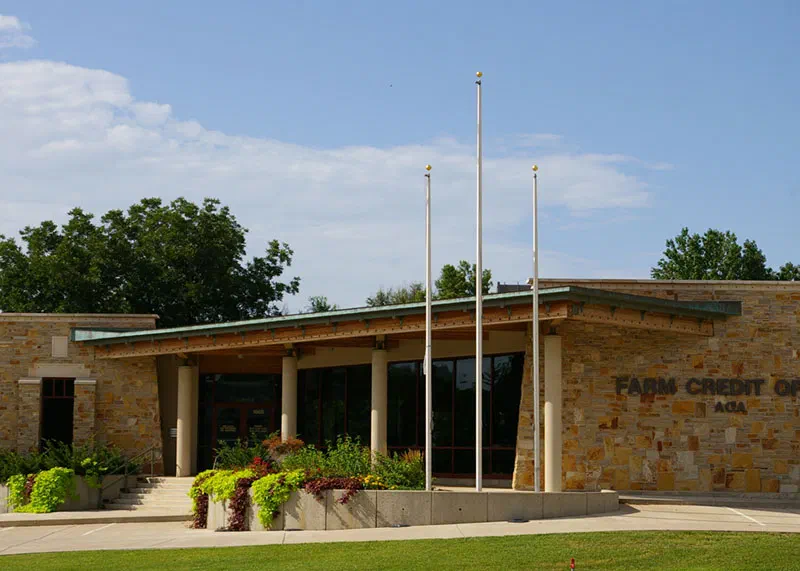 Farm Credit branch office with natural stone walls, deep roof overhangs and flagpoles