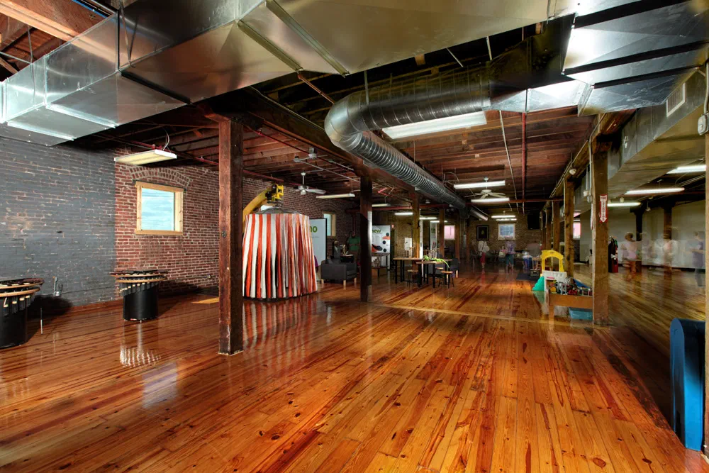 Leonardo's museum gallery with refinished wood floors, exposed brick and industrial ceiling